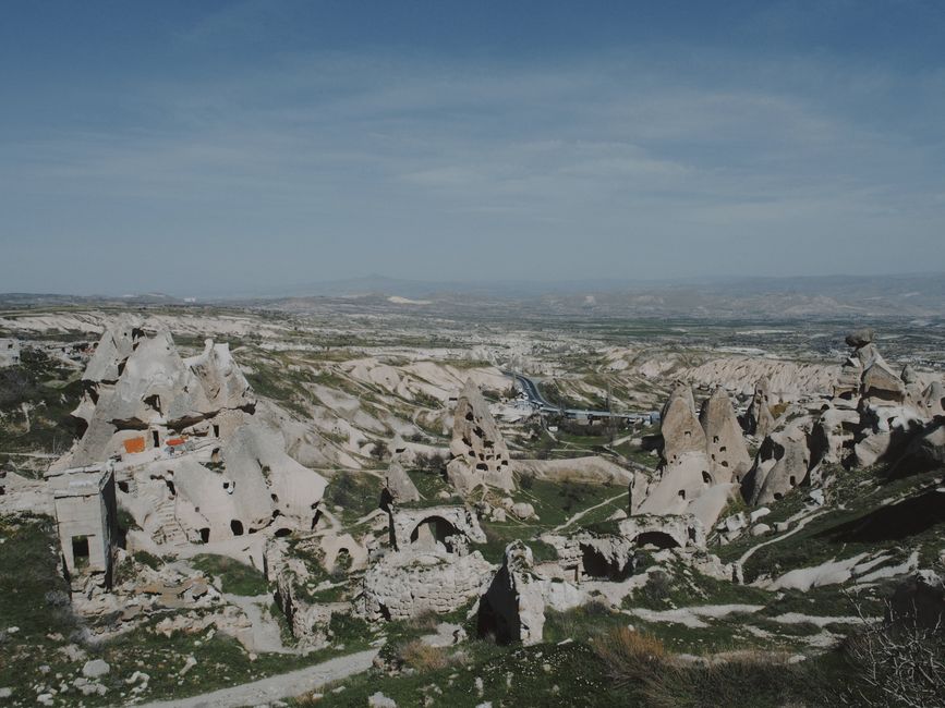 Aerial view of unique rock formations in Cappadocia, Turkey, with vast landscape.